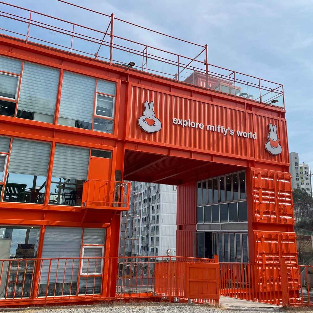 The vibrant orange container exterior of the Miffy Store with the sign 'explore miffy's world' located in Yeongdo, Busan.