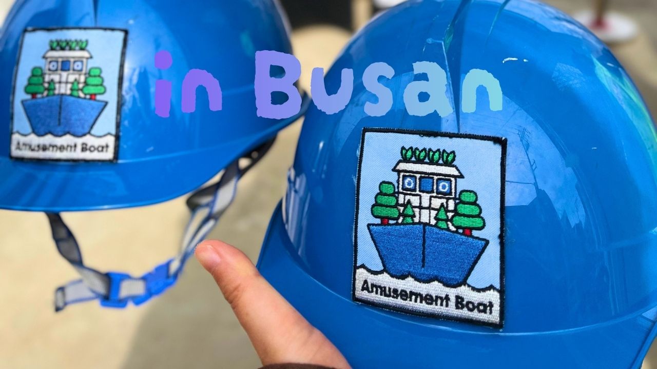 Blue safety helmets with amusement boat logos for the shipyard and floating ship experience at Busan Yeongdo Kangkangee Art Village, South Korea