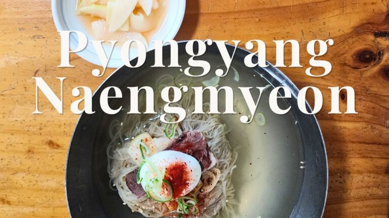 Authentic Pyongyang Naengmyeon cold buckwheat noodles served in a brass bowl with Pyongyang Naengmyeon title overlay